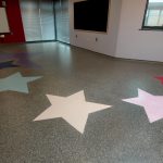 Grey Flake flooring with coloured stars-hardwearing resin flooring-durable flooring