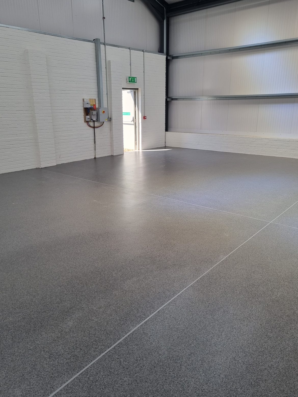 bespoke Resin Flooring Contractor in large open flooring area. When you need reliable, efficient and safe resin flooring contractors, RESYN should be top of your list providing seamless surfacing soltuons